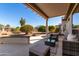 Covered patio with desert landscaping and plenty of space for outdoor living and entertaining at 16476 W Limestone Dr, Surprise, AZ 85374