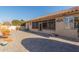 Spacious backyard with a paved patio area and a covered porch, perfect for outdoor entertaining at 17816 W Mariposa Dr, Surprise, AZ 85374