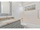 Bathroom with granite vanity, mosaic mirror and bathtub at 17816 W Mariposa Dr, Surprise, AZ 85374