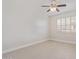 An empty bedroom with neutral walls, tile floors, a ceiling fan, and a window with white shutters at 17816 W Mariposa Dr, Surprise, AZ 85374