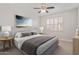 A staged bedroom featuring a plush bed, side tables, and a window with white shutters at 17816 W Mariposa Dr, Surprise, AZ 85374