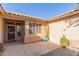 Enclosed courtyard with neutral color stucco walls, desert landscaping, and a view of the front entry at 17816 W Mariposa Dr, Surprise, AZ 85374