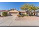 A single-story home with a tile roof, desert landscaping, and an attached two-car garage at 17816 W Mariposa Dr, Surprise, AZ 85374