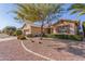 Single story home with desert landscaping, mature trees, and a tile roof at 17816 W Mariposa Dr, Surprise, AZ 85374
