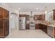 Modern kitchen with stainless steel appliances, granite countertops, and dark wood cabinetry at 17816 W Mariposa Dr, Surprise, AZ 85374