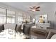 A staged dining and living room filled with natural light, neutral furniture and a ceiling fan at 17816 W Mariposa Dr, Surprise, AZ 85374