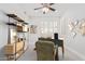 Well-lit home office with a modern desk, custom shelving, and neutral decor at 17816 W Mariposa Dr, Surprise, AZ 85374