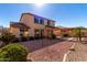 Expansive backyard featuring a covered patio, desert landscaping, and a two-story home with ample windows at 18060 W Rimrock St, Surprise, AZ 85388