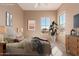Well-lit bedroom with neutral decor, a large window, and modern furnishings at 18060 W Rimrock St, Surprise, AZ 85388