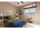 Cheerful bedroom with bright colors, playful decor, and a window with natural light at 18060 W Rimrock St, Surprise, AZ 85388
