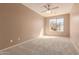 Bright bedroom with carpeting and a large window at 18060 W Rimrock St, Surprise, AZ 85388