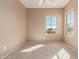 Bright bedroom features neutral carpet and walls, large window with neighborhood views at 18060 W Rimrock St, Surprise, AZ 85388