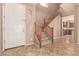 Bright foyer with tile flooring, staircase and view to the kitchen at 18060 W Rimrock St, Surprise, AZ 85388