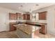 Spacious kitchen features stainless steel appliances, granite countertops, and island at 18060 W Rimrock St, Surprise, AZ 85388