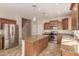Well-equipped kitchen with stainless steel appliances, granite countertops, and a central island at 18060 W Rimrock St, Surprise, AZ 85388