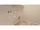The utility room includes washer/dryer hookups and tiled flooring at 18060 W Rimrock St, Surprise, AZ 85388