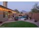 Backyard oasis featuring a pool, patio, artificial turf, and an outdoor seating area at 18681 N 93Rd St, Scottsdale, AZ 85255