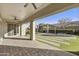 Covered patio overlooking a backyard featuring a pergola with an outdoor grill and an artificial turf lawn at 19235 E Peartree Ln, Queen Creek, AZ 85142