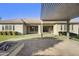 The covered patio extends to a brick paver area with a built in fire pit at 19235 E Peartree Ln, Queen Creek, AZ 85142