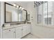 Bright bathroom with a large framed mirror, shutters and a white cabinet vanity at 19235 E Peartree Ln, Queen Creek, AZ 85142