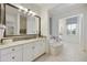 Elegant bathroom featuring double sinks, a soaking tub, and stylish fixtures at 19235 E Peartree Ln, Queen Creek, AZ 85142