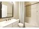 Contemporary bathroom featuring stylish mosaic tile accents, white vanity, and a shower-tub with curtain at 19235 E Peartree Ln, Queen Creek, AZ 85142