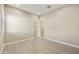 Minimalist bedroom with neutral walls, wood-look tile floors, and bright natural light through window shutters at 19235 E Peartree Ln, Queen Creek, AZ 85142