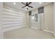 Cozy bedroom with shutters, neutral carpet, fan, and a statement wall at 19235 E Peartree Ln, Queen Creek, AZ 85142