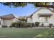 Well-manicured front yard with green grass and mature landscaping complements the home's architecture at 19235 E Peartree Ln, Queen Creek, AZ 85142