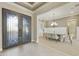 Grand foyer with decorative iron doors leading to an elegant dining room at 19235 E Peartree Ln, Queen Creek, AZ 85142