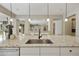 Close-up of kitchen island sink with granite countertop and stainless appliances at 19235 E Peartree Ln, Queen Creek, AZ 85142