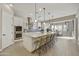 Bright, modern kitchen with large island, stainless appliances, tile floors and blue backsplash at 19235 E Peartree Ln, Queen Creek, AZ 85142