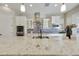 Modern kitchen with white cabinets, granite countertops, a stainless hood, and a decorative tile backsplash at 19235 E Peartree Ln, Queen Creek, AZ 85142