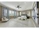 Spacious main bedroom featuring a large bed, stylish decor, and ample natural light at 19235 E Peartree Ln, Queen Creek, AZ 85142