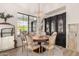 Elegant dining room with a round table, chandelier, and dark wood accents at 20226 E Poco Calle --, Queen Creek, AZ 85142