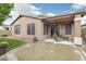 A spacious backyard featuring an outdoor seating area, a grass lawn, and privacy walls at 20529 N 94Th Ln, Peoria, AZ 85382