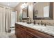 Bright bathroom featuring a stand up shower, tile accents, granite countertops, and dual sinks at 20529 N 94Th Ln, Peoria, AZ 85382