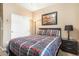 Cozy bedroom featuring warm colors, a queen bed, and a sliding door closet at 20529 N 94Th Ln, Peoria, AZ 85382