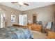 Bedroom with ensuite, featuring neutral tones, light wood furniture, and a ceiling fan at 20529 N 94Th Ln, Peoria, AZ 85382