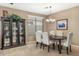 Dining area features a table, chandelier and a display cabinet at 20529 N 94Th Ln, Peoria, AZ 85382