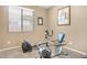 An exercise room featuring neutral colors, exercise bike, rowing machine, and natural light at 20529 N 94Th Ln, Peoria, AZ 85382