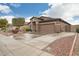 Charming single-story home showcasing desert landscaping, a two-car garage, and a neat front yard at 20529 N 94Th Ln, Peoria, AZ 85382