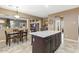 Open kitchen with a large center island, stainless appliances, and eat in dining area overlooking the backyard at 20529 N 94Th Ln, Peoria, AZ 85382