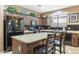 Spacious kitchen featuring dark cabinets, tile floors and island seating at 20529 N 94Th Ln, Peoria, AZ 85382