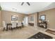 Open-concept layout of living and dining area with neutral color palette at 20529 N 94Th Ln, Peoria, AZ 85382