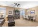 Cozy living room featuring carpet floors, elegant decor, and a ceiling fan at 20529 N 94Th Ln, Peoria, AZ 85382