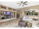 Open floor plan with living room featuring custom built-ins and a seamless flow into the adjacent kitchen at 20529 N 94Th Ln, Peoria, AZ 85382