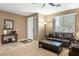 Comfortable living room with tile and carpet flooring, with a decorative table at 20529 N 94Th Ln, Peoria, AZ 85382
