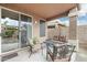 Relaxing covered patio featuring neutral colors, an outdoor seating area, and access to the backyard at 20529 N 94Th Ln, Peoria, AZ 85382