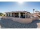 Picture of a home's back patio with tan stucco exterior and low-maintenance desert landscaping at 21730 N Black Bear Lodge Dr, Surprise, AZ 85387